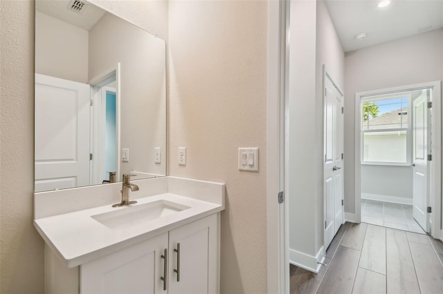 2735 36th Ave N, Saint Petersburg, FL 33713 - bathroom featuring vanity, wood finished floors, and baseboards