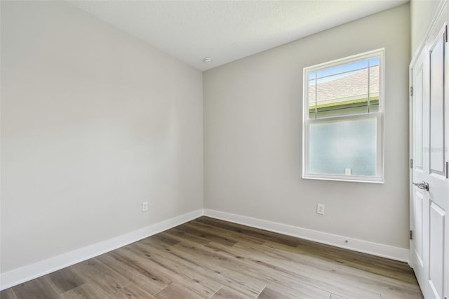 2735 36th Ave N, Saint Petersburg, FL 33713 - empty room with wood finished floors, baseboards, and a smoke detector