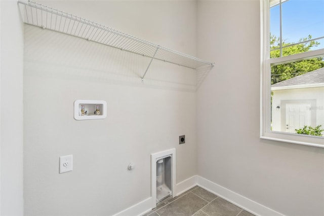 2735 36th Ave N, Saint Petersburg, FL 33713 - washroom with electric dryer hookup, washer hookup, baseboards, hookup for a gas dryer, and tile patterned floors