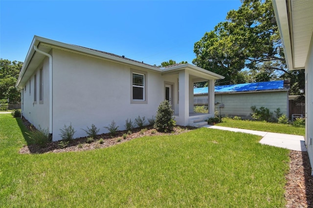 2735 36th Ave N, Saint Petersburg, FL 33713 - view of side of home with a yard and stucco siding