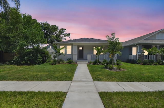 2735 36th Ave N, Saint Petersburg, FL 33713 - view of front of house with covered porch, a front lawn, and stucco siding