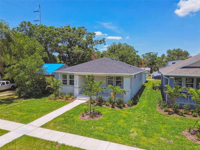 2735 36th Ave N, Saint Petersburg, FL 33713 - view of front facade with covered porch, stucco siding, and a front lawn