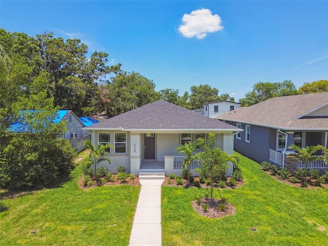 2735 36th Ave N, Saint Petersburg, FL 33713 - bungalow-style house with a porch, a front lawn, stucco siding, and roof with shingles