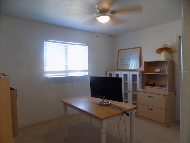 carpeted office featuring ceiling fan