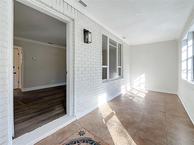 interior space featuring brick wall and crown molding