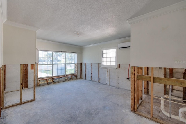 carpeted empty room featuring a wall mounted air conditioner, ornamental molding, and a textured ceiling