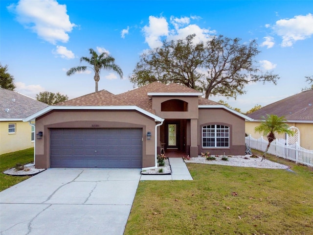 view of front of house featuring a front yard and a garage