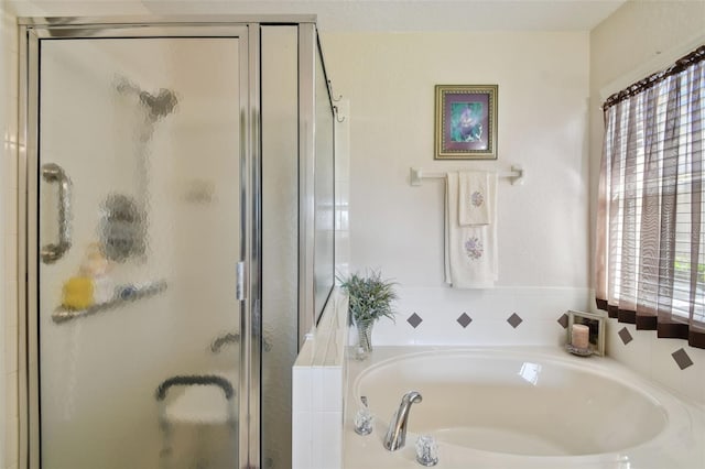 bathroom featuring separate shower and tub