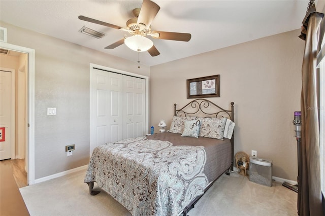 carpeted bedroom featuring ceiling fan and a closet