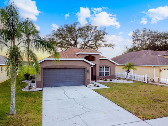 view of front of property with a garage and a front lawn