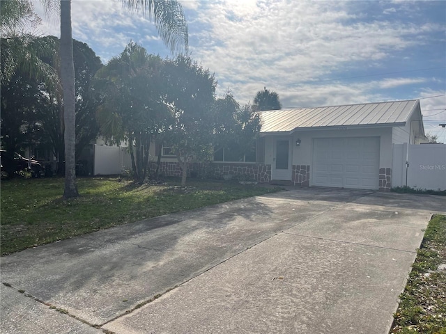 view of front of property with a front yard and a garage