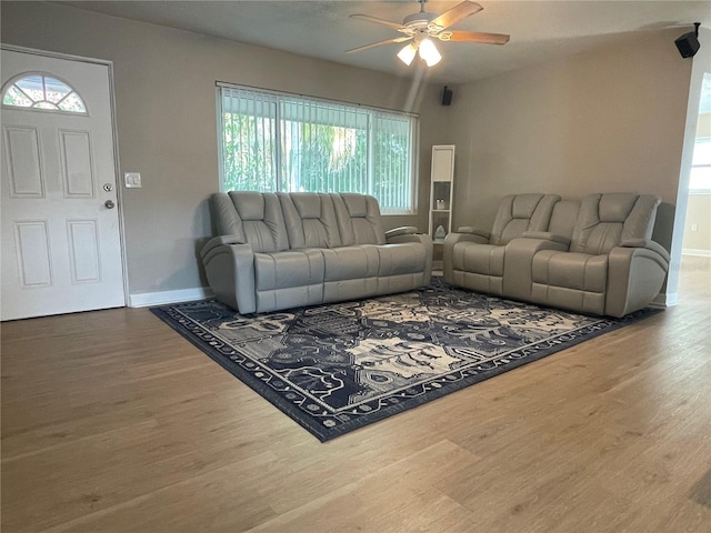 living room with a wealth of natural light, hardwood / wood-style floors, and ceiling fan