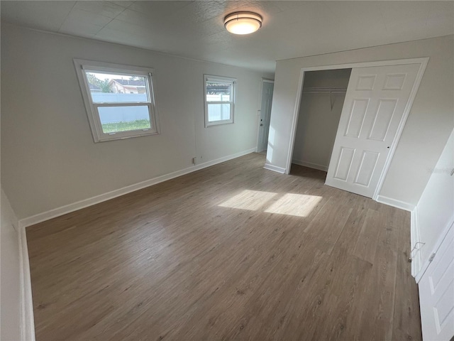 unfurnished bedroom featuring a closet and light wood-type flooring