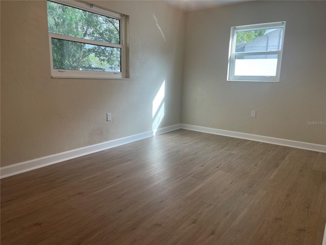 spare room with wood-type flooring