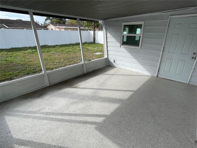 unfurnished sunroom featuring vaulted ceiling