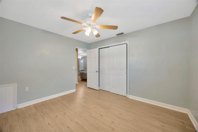 6598 26th St N, Saint Petersburg, FL 33702 - unfurnished bedroom featuring light wood-type flooring, ceiling fan, and a closet