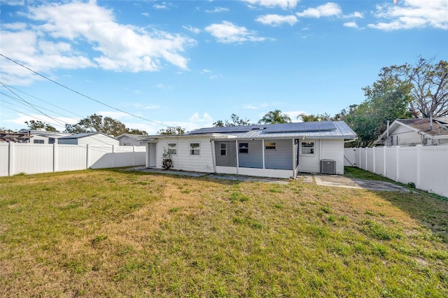 6598 26th St N, Saint Petersburg, FL 33702 - back of property with a sunroom, central AC unit, and a lawn