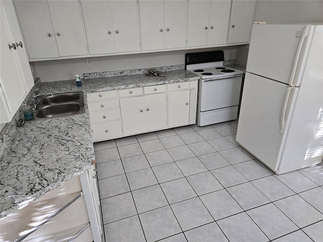 kitchen featuring sink, white cabinets, light tile patterned flooring, and white appliances