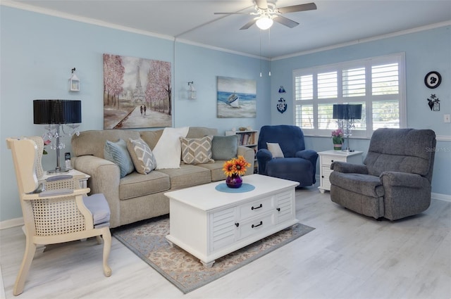 living room with crown molding, ceiling fan, and light hardwood / wood-style floors