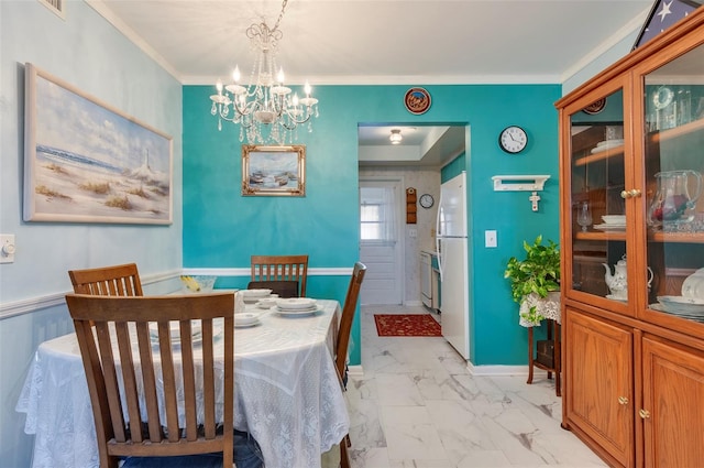 dining area with an inviting chandelier and crown molding