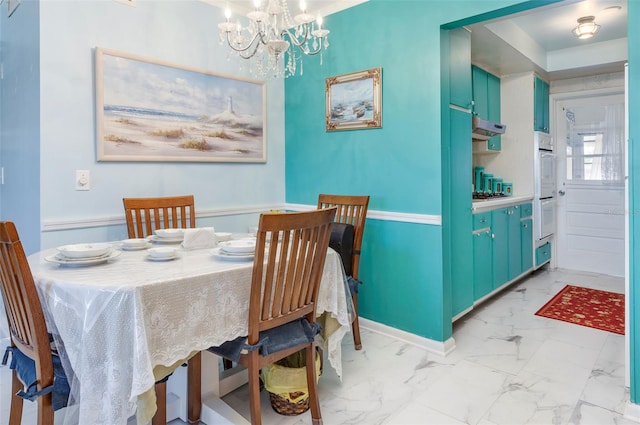 dining space with an inviting chandelier