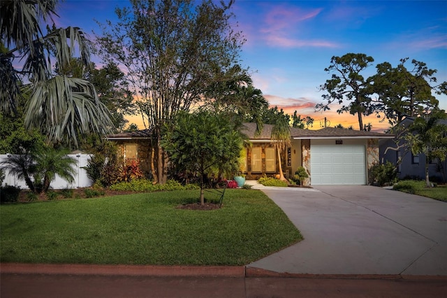 view of front facade with a yard and a garage