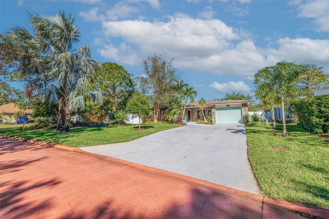 view of front of property featuring a front yard and a garage