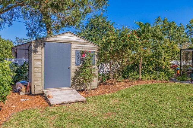 view of outbuilding featuring a lawn