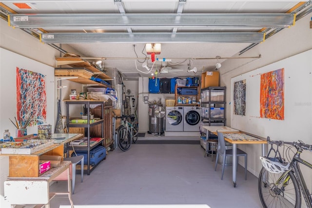 garage with a workshop area and washing machine and clothes dryer