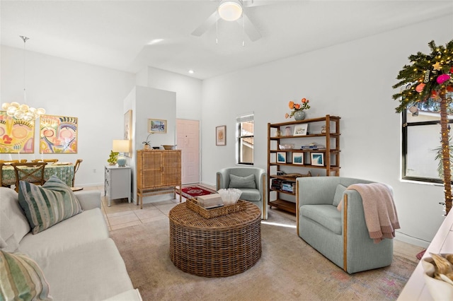 living room featuring ceiling fan, light carpet, and a wealth of natural light