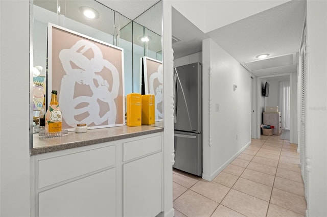 corridor with light tile patterned flooring