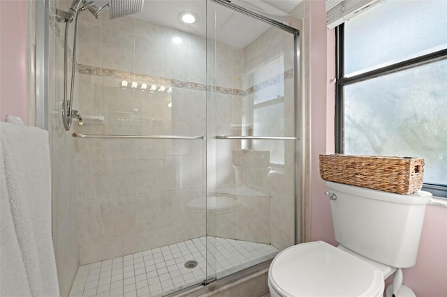 bathroom with toilet and walk in shower