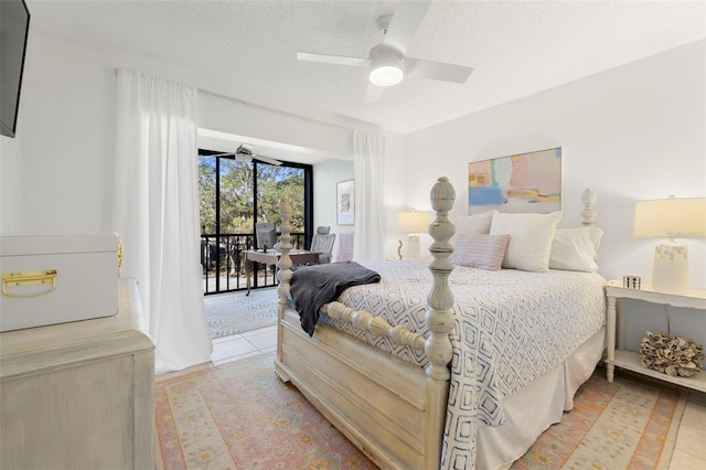 bedroom with access to exterior, ceiling fan, light tile patterned floors, and a textured ceiling