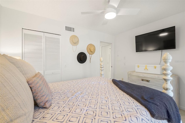 bedroom with ceiling fan and a closet