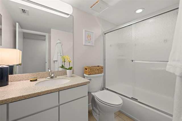 full bathroom with tile patterned flooring, vanity, toilet, and enclosed tub / shower combo