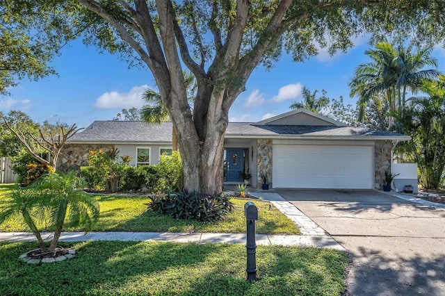 single story home featuring a garage and a front lawn