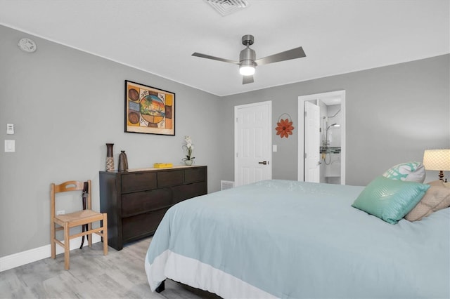 bedroom with ensuite bath, ceiling fan, and light hardwood / wood-style flooring