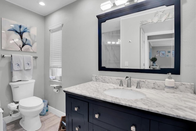 bathroom featuring hardwood / wood-style floors, vanity, and toilet