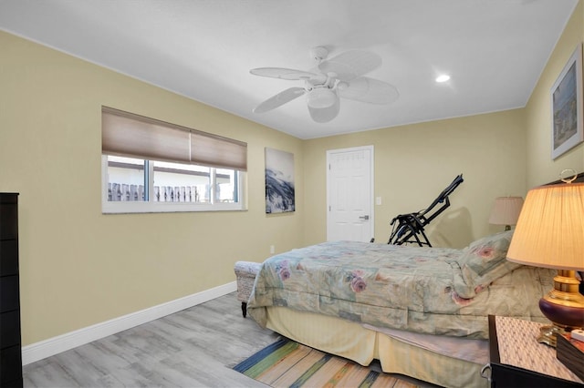 bedroom with ceiling fan and light wood-type flooring