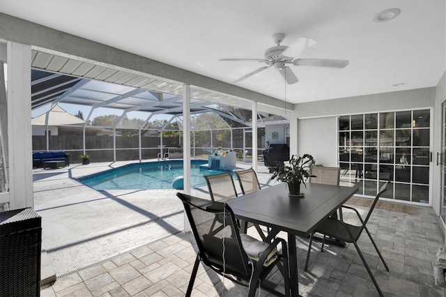 view of swimming pool featuring glass enclosure, ceiling fan, a patio area, and a grill