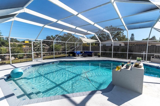 view of pool with a lanai and a patio