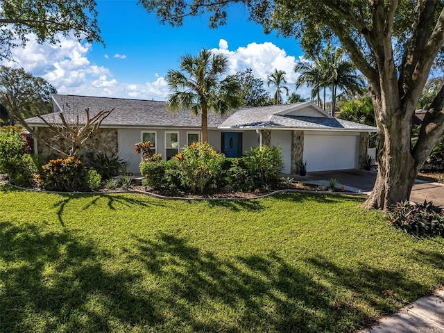 single story home featuring a garage and a front lawn