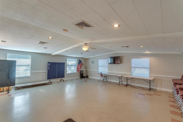 interior space with vaulted ceiling with beams and ceiling fan