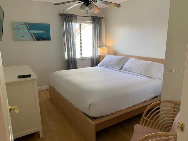 bedroom with ceiling fan and light hardwood / wood-style flooring