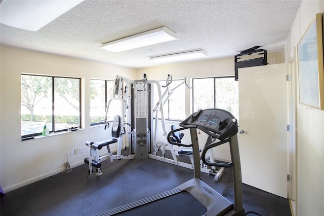 workout room with a textured ceiling