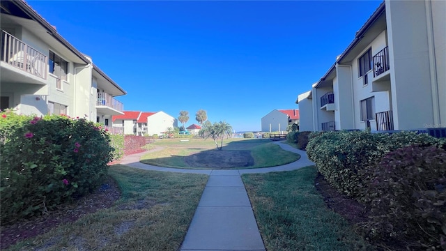 view of property's community featuring a yard