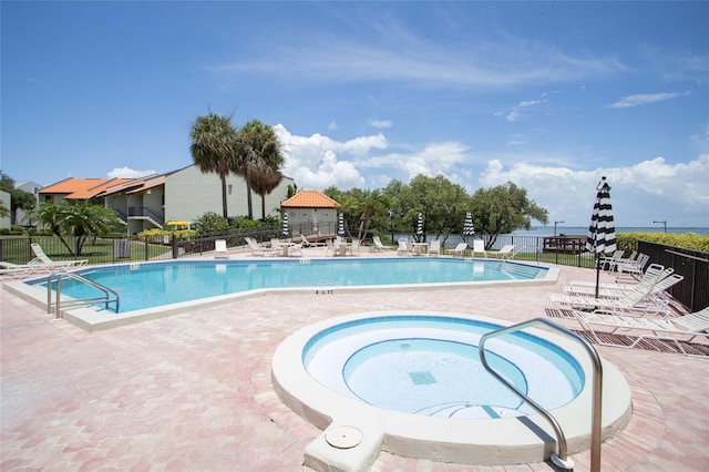 view of pool featuring a patio area and a hot tub