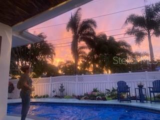 view of pool at dusk