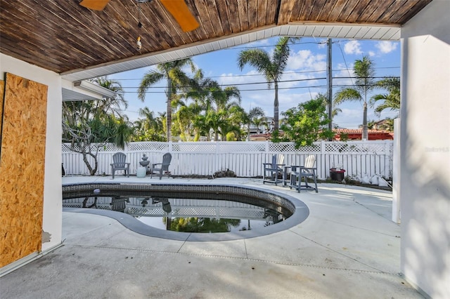 view of pool with a patio and ceiling fan