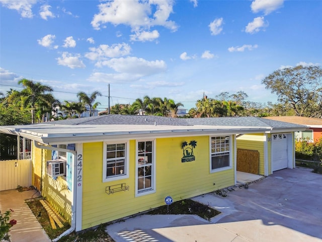 view of front of house with a garage and cooling unit